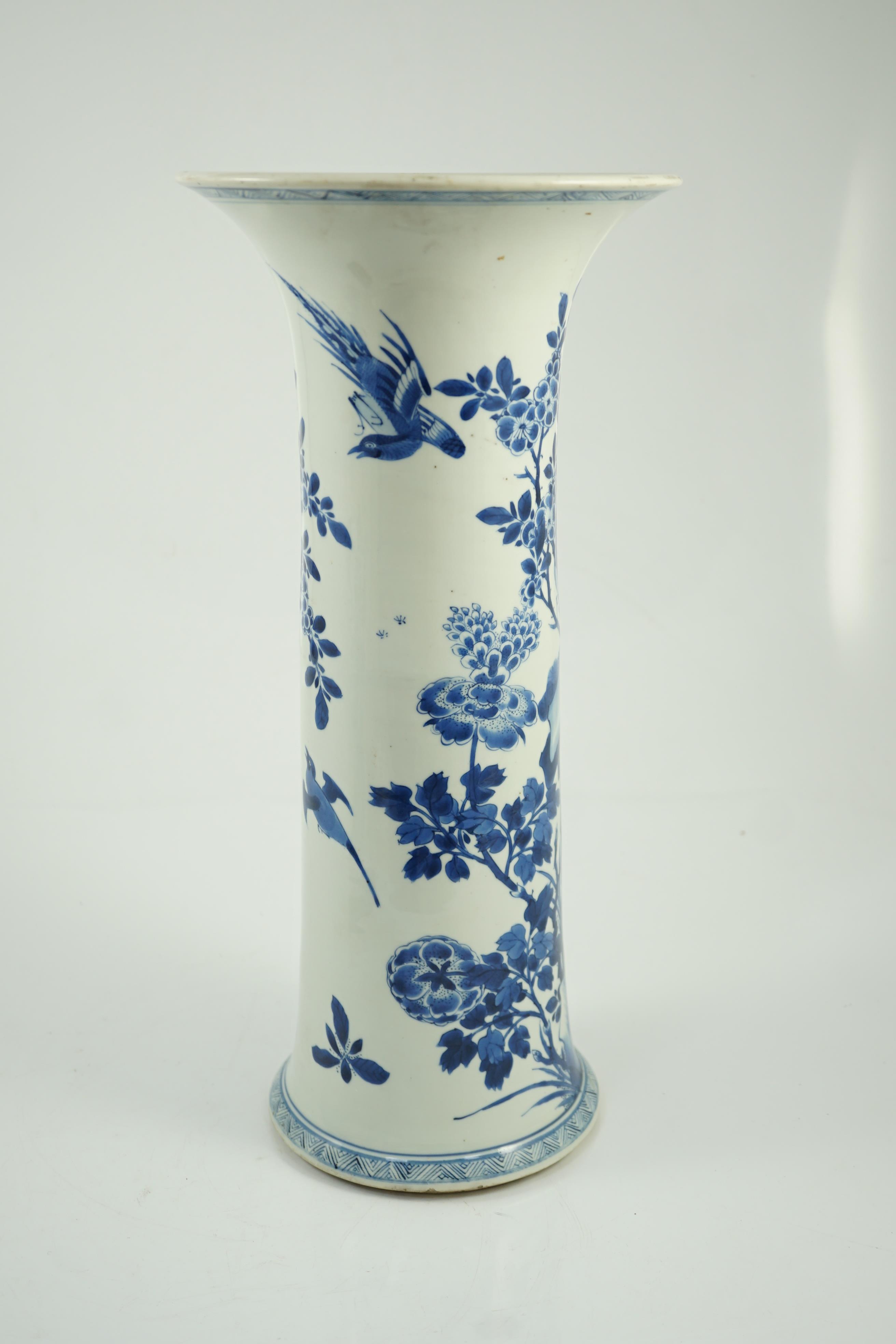 A tall Chinese blue and white ‘pheasants and rocks’ beaker vase, gu, Kangxi period, minor faults